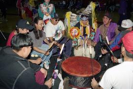 Men play drums at a pow wow, St. Cloud State University