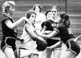 St. Cloud State University basketball player Dawn Anderson is surrounded by North Dakota State University players