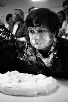 Man participates in homecoming pie eating contest, St. Cloud State University