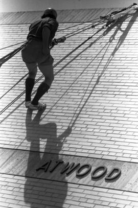 Joel Dhien climbs up the wall of Atwood Memorial Center (1966), St. Cloud State University