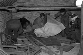 People look for bats in the attic of Riverview (1913), St. Cloud State University