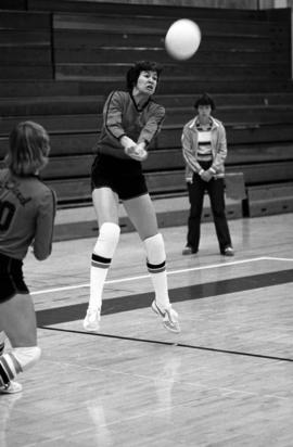 Volleyball player Sue Wahl hits a volleyball during a game against Southwest State University at Halebeck Hall (1965), St. Cloud State University