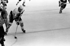 St. Cloud State hockey player Pat Sullivan handles the puck against Hamline University in men's hockey