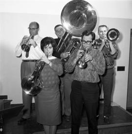 Men and women stand together playing musical instruments, St. Cloud State University