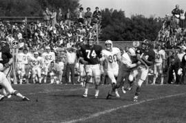 Quarterback throws a pass during a football game against St. John's University, St. Cloud State University