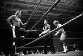 Wrestler Brad Rheingans faces off against Wayne Bloom in a match at the Sauk Rapids High School