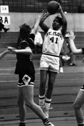 Toni Jameson shoots a basketball against Mankato State University, St. Cloud State University, St. Cloud State University