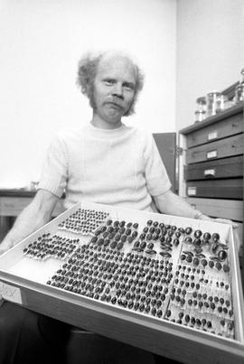 Ralph Gundersen displays his collection of water beetles