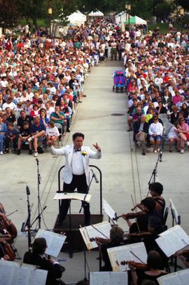 Man conducts an orchestra, Lemonade Concert and Art Fair, St. Cloud State University