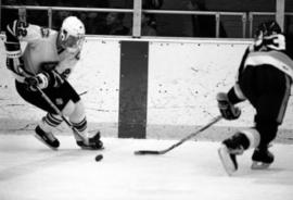 Hockey player Herm Finnegan skates with the puck during a game against Ferris State University