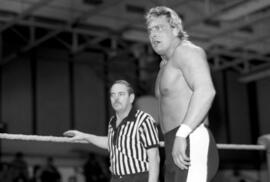 Wrestler Wayne Bloom stands with Marty Miller during a match at the Sauk Rapids High School