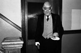 Man stands in a stairwell at the haunted Halloween Carnegie library event, St. Cloud State University