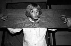 Woman stands in a stockade at the haunted Halloween Carnegie library event, St. Cloud State University