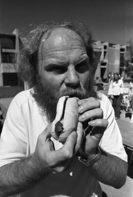 Dave Wogen eats a hot dog at Greek Week, St. Cloud State University, May 1980