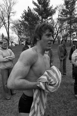 Curt Quiner dries off after swimming across the Mississippi River, St. Cloud State University