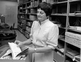 Marie Elsen inspects records in University Archives, St. Cloud State University