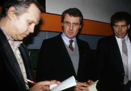 Herb Brooks and Morris Kurtz talk to a reporter after the Division III third place hockey game, St. Cloud State University