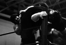 Wrestler Ricky Martel tries to throw Jerry Blackwell over the top rope during a wrestling match at Halenbeck Hall (1965), St. Cloud State University