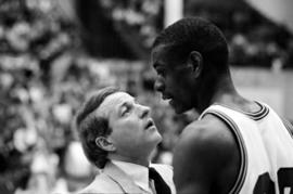 Coach Butch Raymond talks to player Kevin Catron during a basketball game against University of North Dakota, St. Cloud State University