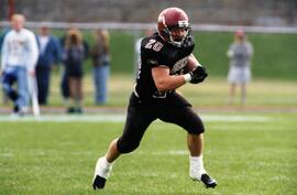 Randy Martin runs with a football during a game, St. Cloud State University