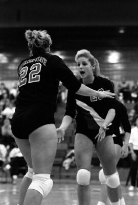 Sheri Mandell congratulates a teammate during a volleyball match, St. Cloud State University