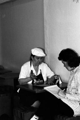 Two women sit together at a table at Bravo Burritos