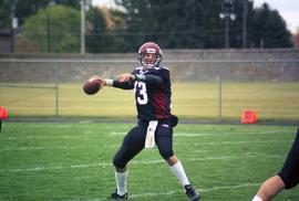 Quarterback Keith Heckendorn throws the ball against the University of South Dakota, St. Cloud State University