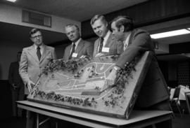 President Charles Graham, Al Loehr and others display a model of the Minnesota Highway Safety Center, St. Cloud State University