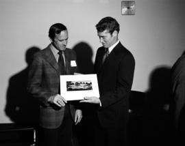 Minnesota governor Wendell Anderson and another man holds an architectural rendering of Administrative Services (1975), St. Cloud State University