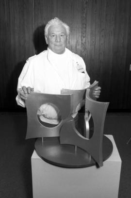 Artist Charles Huntington with a model of his sculpture "Perspectives," St. Cloud State...