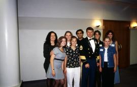 University Program Board employee Jessica Fitch Ostman and students stand with a man in uniform, St. Cloud State University