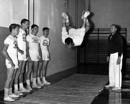 Man swings on gymnastic rings, St. Cloud State University