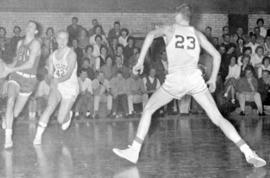 St. Cloud State basketball player John Blomlie follows a Moorhead State player during a men's basketball game