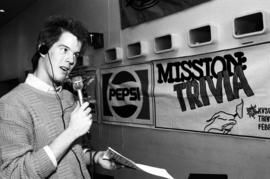 A man speaks into a microphone, KVSC trivia weekend, St. Cloud State University