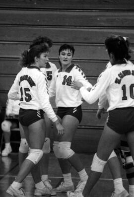 Kathy Davis congratulates teammates during a volleyball match, St. Cloud State University