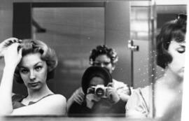 Women look in the mirror to prepare for their days, St. Cloud State University