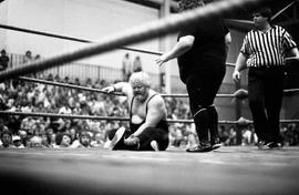 Wrestler Larry "The Ax" Hennig sits on the ring floor during his match against Jerry Blackwell at Halenbeck Hall (1965), St. Cloud State University