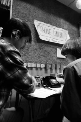 A man and woman answer telephones during KVSC trivia weekend, St. Cloud State University