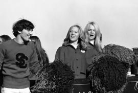 Cheerleaders ride on a homecoming parade float, St. Cloud State University