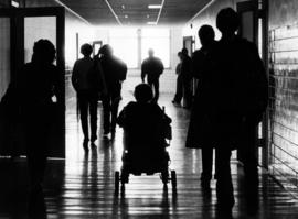 Student Lis Kristensen uses her wheelchair in a hallway, St. Cloud State University