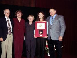 The parents of Dennis Thayer and others stand with the winner of the Thayer award at the Excellence in Leadership awards dinner, St. Cloud State University