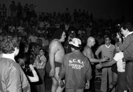 Andre the Giant and Baron Von Raschke walk to the wrestling ring before a wrestling match at Halenbeck Hall (1965), St. Cloud State University