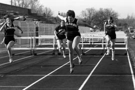 St. Cloud State University track athlete Sue Wahl beats teammates Debbie Mahoney and Deb Krats during the 100 meter hurdle race at a track meet at Selke Field (1937)