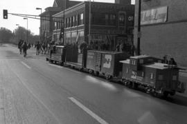 A miniature train participates in the homecoming parade in downtown St. Cloud, St. Cloud State University