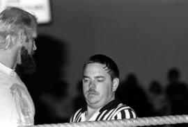 Wrestling referee Marty Miller talks to Jesse Ventura at Halenbeck Hall (1965), St. Cloud State University