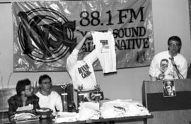 A man holds up a t-shirt during the KVSC trivia weekend closing ceremonies, St. Cloud State University