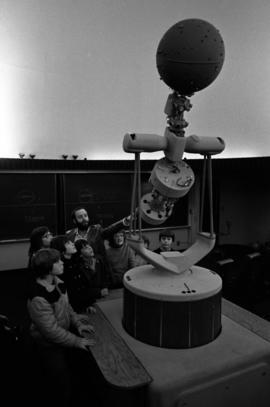 People look at the planetarium equipment in the Mathematics and Science Center (1973), St. Cloud State University