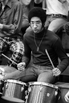 Man plays the drums at a St. Cloud State men's basketball game against University of Wisconsin-Stout