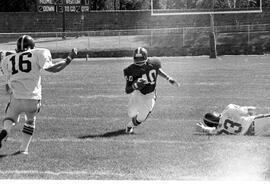 Football player John Kimbrough runs with the football against the University of South Dakota, St. Cloud State University