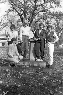 Women's basketball players Sandy Ahles, Janice Flicker, Sarah Howard, Dawn Anderson, and Carol Thelen stand in Barden Park, St. Cloud State University